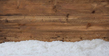 Snow on wooden background with copy spaceの写真素材