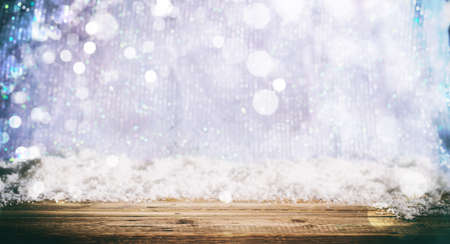 Wooden surface and Christmas snowy bokeh backgroundの写真素材