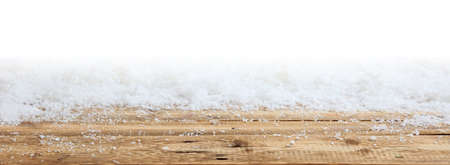 Wooden surface and Christmas snowy bokeh backgroundの写真素材