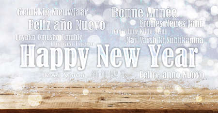 Happy new year wish in many languages on snowy background