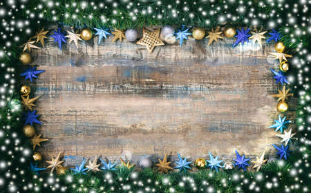 Christmas ornaments and green garland on a wooden board, copy spaceの写真素材