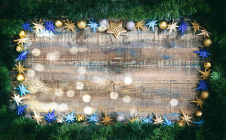 Christmas ornaments and green garland on a wooden board, copy spaceの写真素材