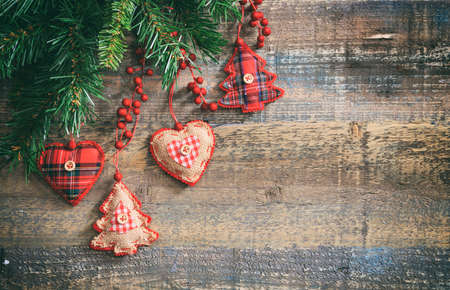 Christmas ornaments and green garland on a wooden board, copy spaceの写真素材