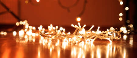 Christmas lights on wooden floor, bokeh background,の写真素材