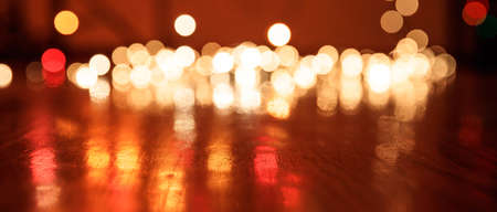 Christmas lights bokeh background on wooden floor, copy spaceの写真素材