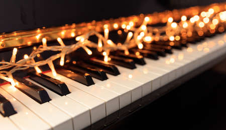 Christmas lights on a classical piano keyboardの写真素材