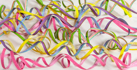 Colorful carnival serpentines on white wooden background, top niewの写真素材