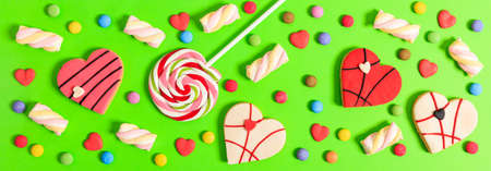 Colorful candies on bright green background, top viewの写真素材