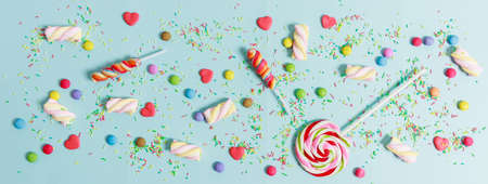 Colorful candies on light blue background, top viewの写真素材