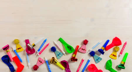 Colorful birthday party supplies on wooden background, top niew and copy spaceの写真素材