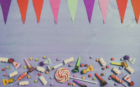 Colorful birthday party supplies on blue wooden background, top niew and copy spaceの写真素材