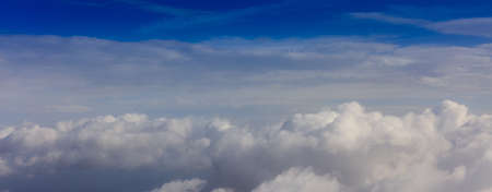 Fluffy white clouds on a blue sky background. Space for text.の写真素材