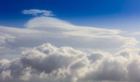 Fluffy white clouds on a blue sky background. Space for text.の写真素材