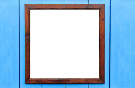 Blank wooden frame on the wall. White inside and light blue background, space for text.の写真素材