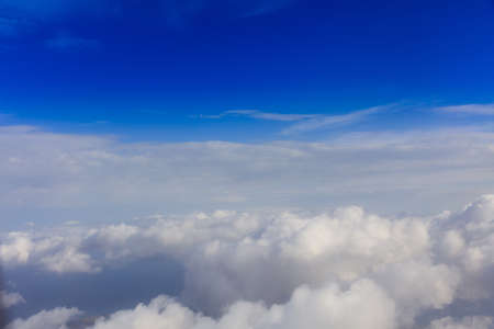 Fluffy white clouds on a blue sky background. Space for text.の写真素材