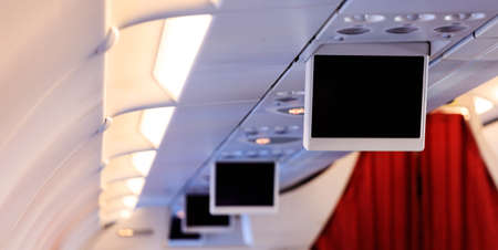 Aircraft's tv screens in a row. Copyspace and blank, black screen.のeditorial素材
