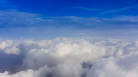 Fluffy white clouds on a blue sky background. Space for text.の写真素材