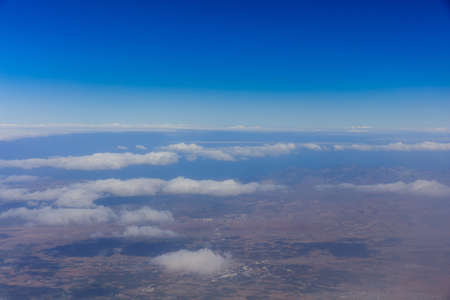 Planet earth. Blue sky, white clouds, land. Aerial shot.の写真素材