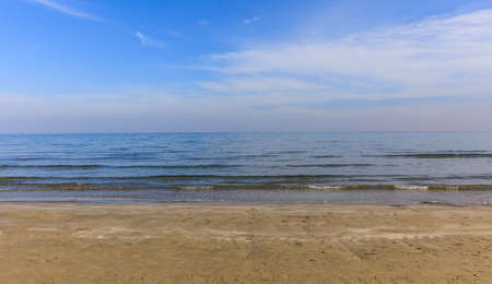Empty sandy beach. Blue sky with few clouds and sea at evening. Closeup view.の写真素材