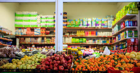 Fruits and olives in row with details. Blurred products in market store. Close up view.のeditorial素材