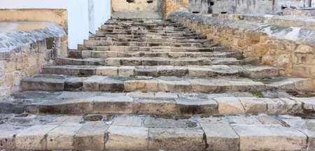 Old weathered stone stairs and walls background. Close up view with details.の写真素材
