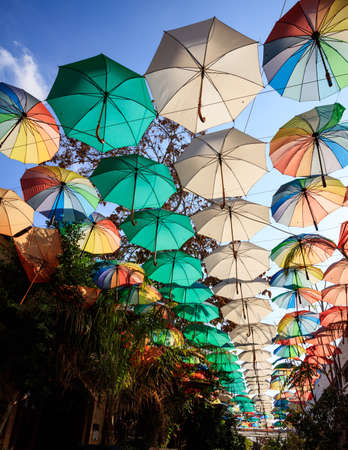 Multicolored open umbrellas decorate a narrow street at Nicosia, Cyprus. Protection from sun and rain.の写真素材