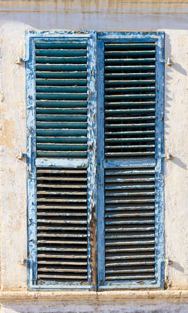 Wooden worn window on peeling light pink backdrop. Close up view with details.の写真素材