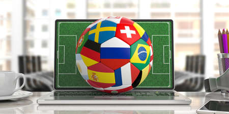 Russia soccer football ball with world teams flags on a laptop keyboard, blurred office background. 3d illustrationの写真素材