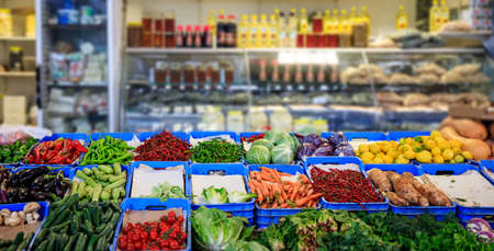 Fresh vegetables displayed on supermarket boxes. Closeup view with details. Blurred background.の写真素材