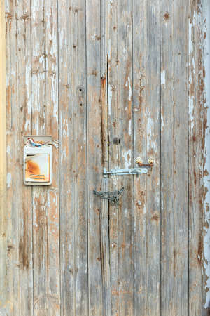 Wooden old and peeled door for backdrop. Close up view with detailsの写真素材