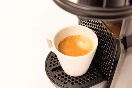 Espresso coffee maker machine. Ready coffee, modern design, white background, closeup view, details.の写真素材