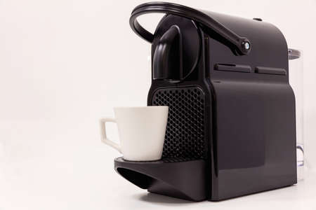 Espresso coffee maker machine with modern design. White background, close up view with details.の写真素材