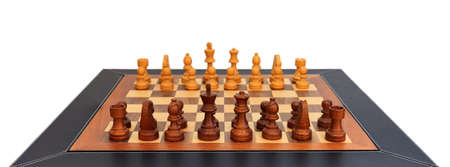 Wooden chessboard with chess pieces on it. Leather frame, close up view, details, white background.の写真素材