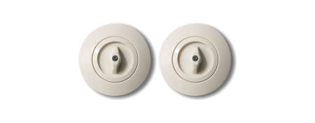 Two switches vintage round with button from porcelain isolated on white background. Close up view, detail.の写真素材