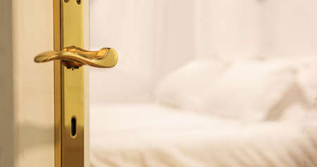 Hotel's blurred bedroom from opened door. White background, close up view, details of the doorway.の写真素材