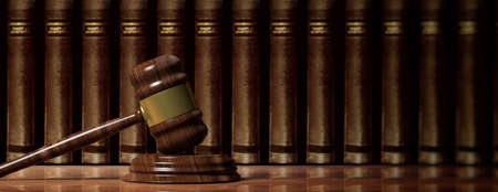 Law concept. Wooden judge gavel on law books background, banner. 3d illustrationの写真素材