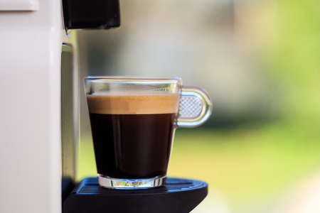 Making espresso. Espresso coffee maker on a blurred background, space for text, front viewの写真素材
