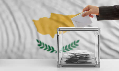 Cyprus elections concept. Voter's hand on Cyprus waving flag background. 3d illustrationの写真素材