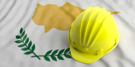 Construction industry in Cyprus. Yellow hard hat on Cyprus waving flag background. 3d illustrationの写真素材