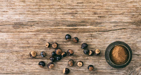 Guarana beans and powder on wooden background, top view, copy spaceの写真素材
