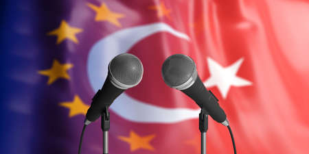 Relationship between European Union and Turkey. Two cable microphones in front of blurred flags for backdrop. 3d illustrationの写真素材