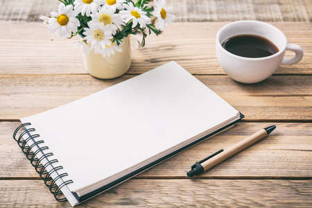 Blank empty notebook, wooden background, view from above, space for textの写真素材