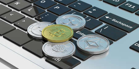 Cryptocurrency concept. Golden bitcoin and variety of silver virtual coins  on a computer keyboard....