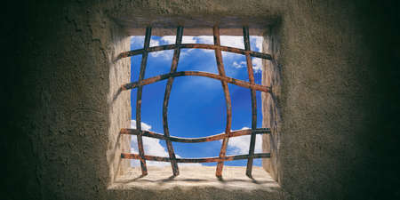 Escape, freedom concept. Prison, jail window with blue sky view, rusty open bended bars on old wall...