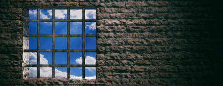 Prison, jail window with rusty bars and blue sky view on brick wall background. Banner, space for...