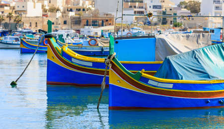 Marsaxlokk, Malta island. Traditional fishing boats luzzus with bright colors anchored at the port of Marsaxlokk. Closeup viewの写真素材