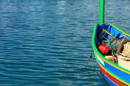 Traditional colorful boat luzzu detail at the port of Marsaxlokk, Malta. Copy space, closeup viewの写真素材