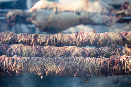Whole kokorec and lamp spits on coals fire. Greek Easter, Monastiraki, Athens Greeceの写真素材