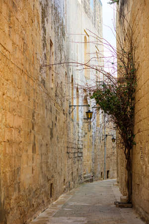 Mdina, Malta island. Old medieval city narrow streets, houses sandstone facades and lanternsの写真素材