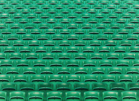 Rows of green empty folding stadium seats backgroundの写真素材